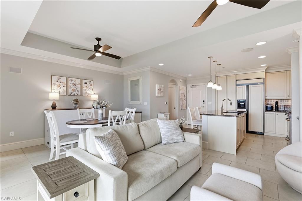 9123 Strada Place, Unit 7409 Naples, FL 34108 - Photo 4 of 34 a living room with furniture and a view of kitchen