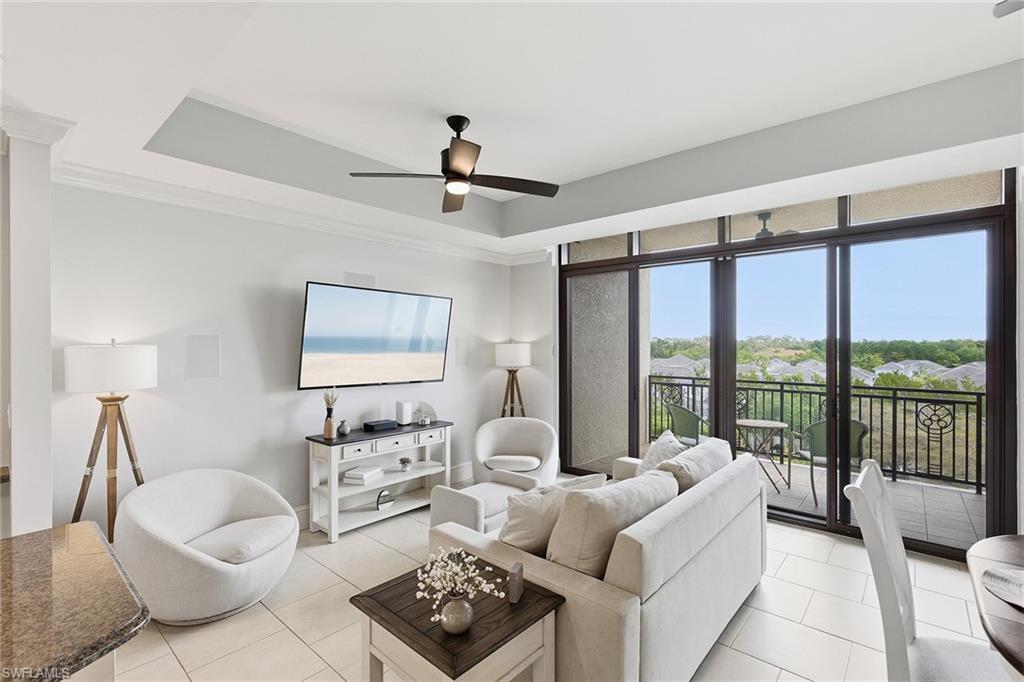 9123 Strada Place, Unit 7409 Naples, FL 34108 - Photo 8 of 34 a living room with furniture and a large window