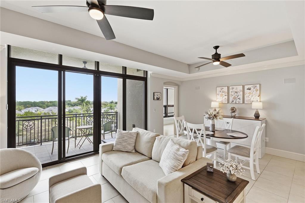 9123 Strada Place, Unit 7409 Naples, FL 34108 - Photo 9 of 34 a living room with furniture and a large window