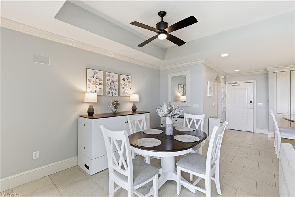 9123 Strada Place, Unit 7409 Naples, FL 34108 - Photo 10 of 34 a dining room with furniture and window