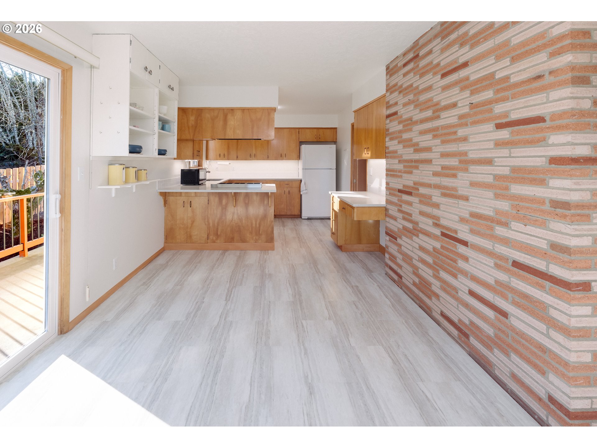 14285 Southwest 114th Avenue Tigard, OR 97224 - Photo 11 of 42 a kitchen with stainless steel appliances wooden floors and white walls