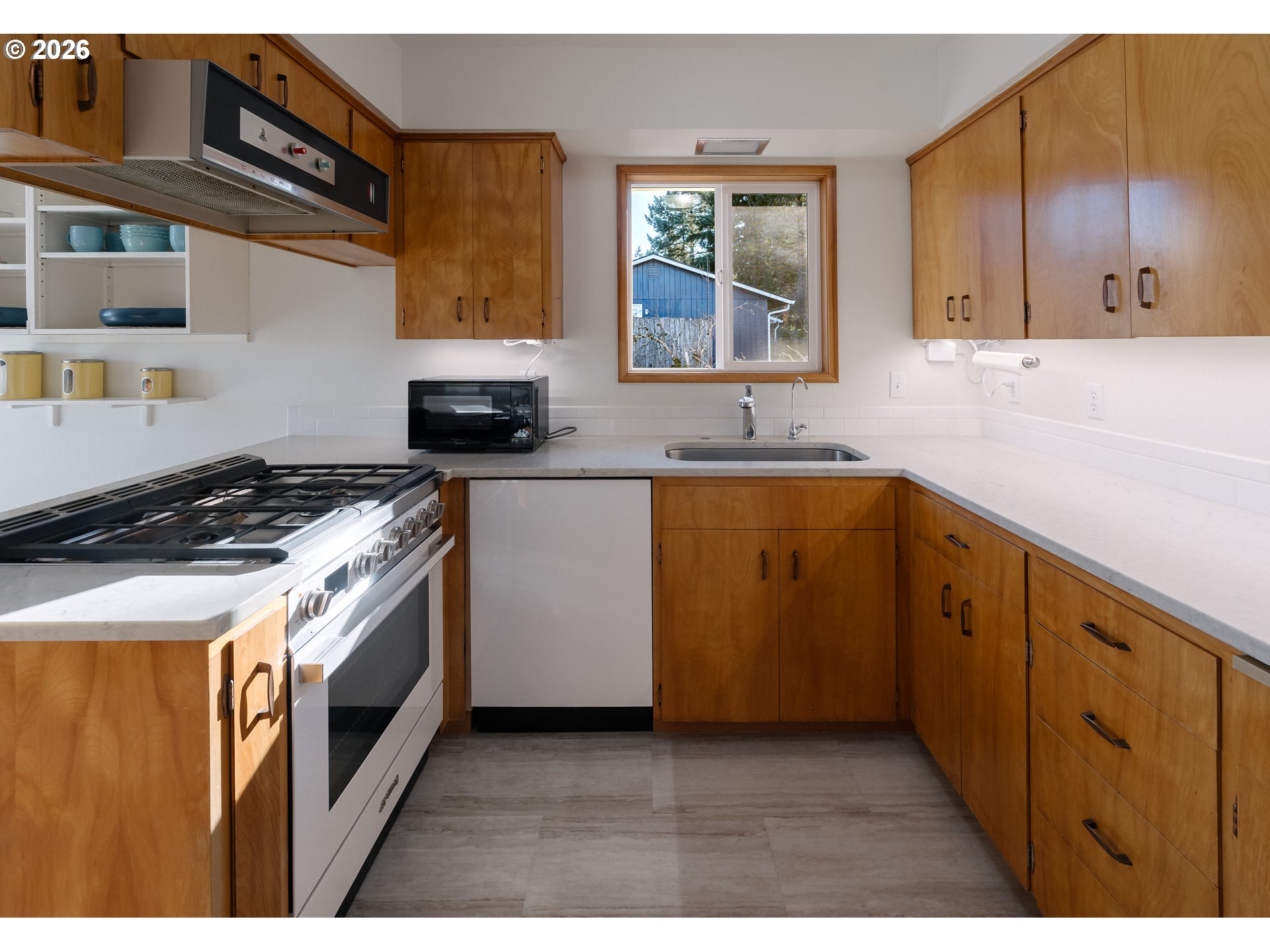 14285 Southwest 114th Avenue Tigard, OR 97224 - Photo 12 of 42 a kitchen with stainless steel appliances granite countertop a stove a sink and a microwave
