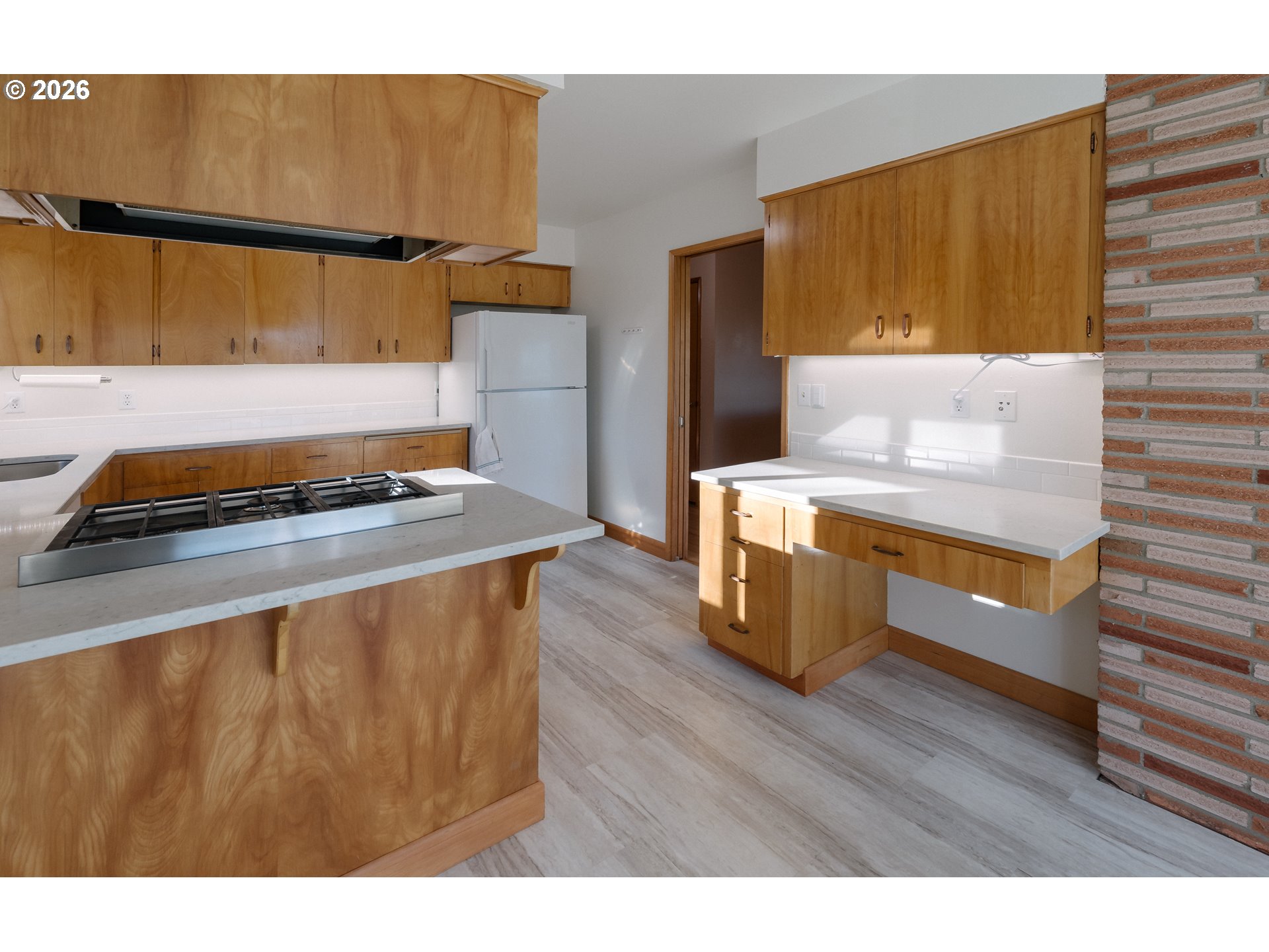 14285 Southwest 114th Avenue Tigard, OR 97224 - Photo 14 of 42 a kitchen with a wooden floor and a stove top oven