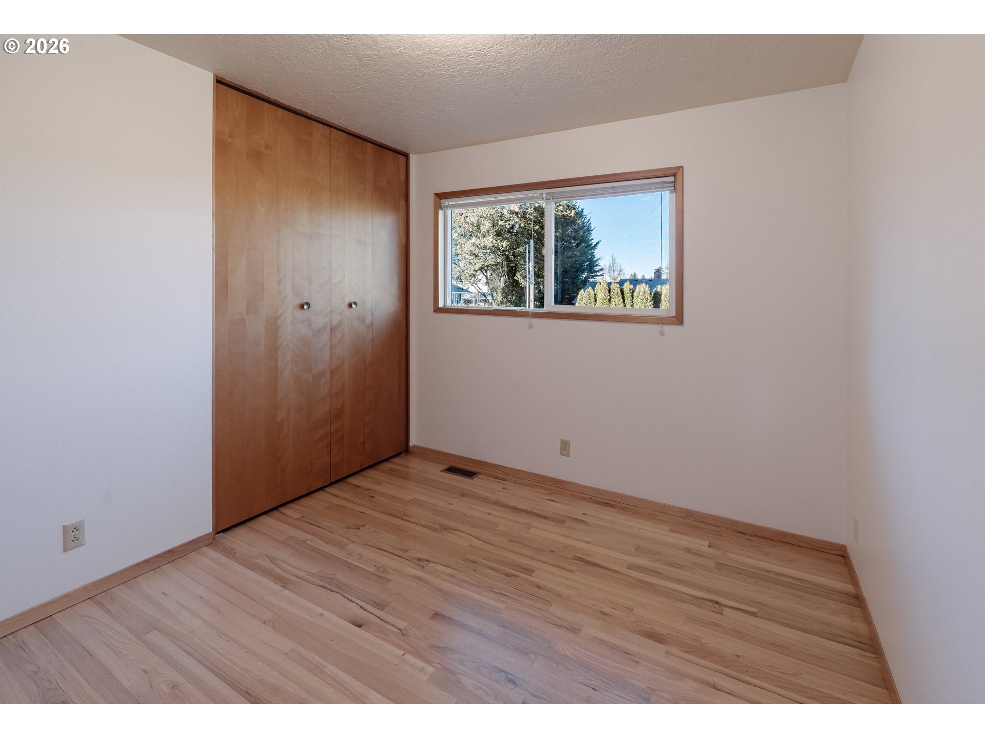 14285 Southwest 114th Avenue Tigard, OR 97224 - Photo 23 of 42 an empty room with wooden floor and window