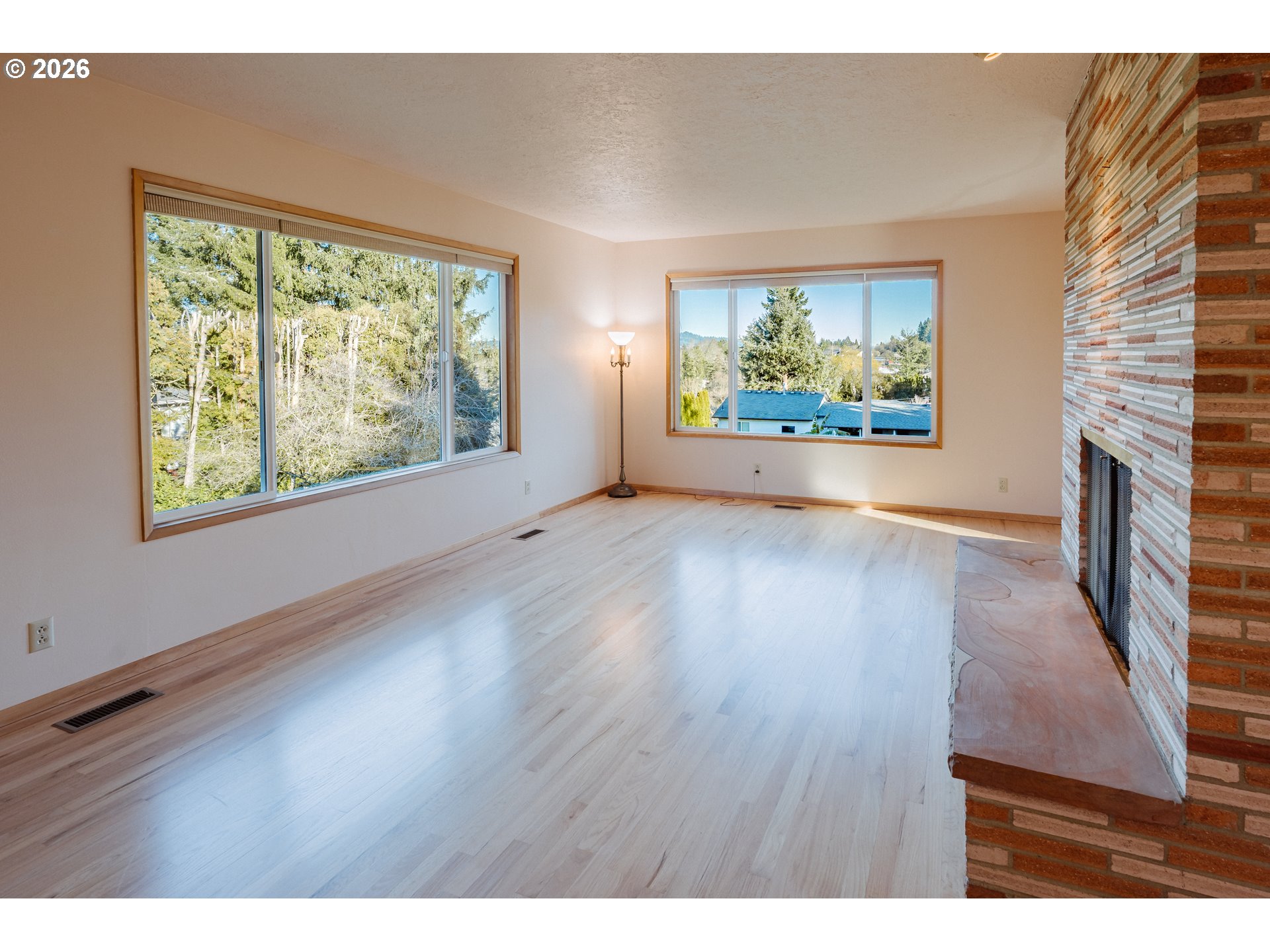 14285 Southwest 114th Avenue Tigard, OR 97224 - Photo 6 of 42 a view of an empty room with a window and wooden floor
