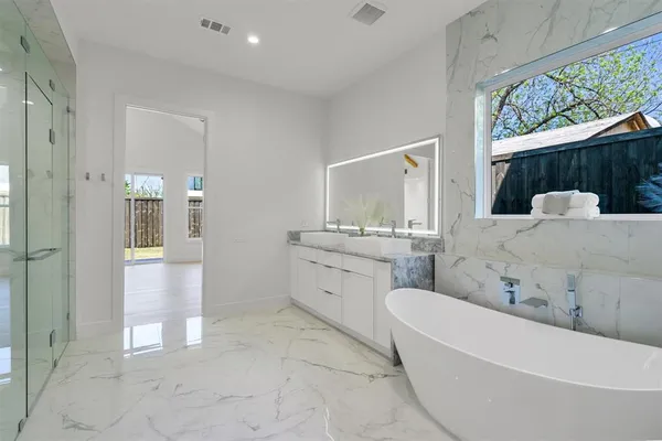a kitchen with granite countertop white cabinets and a sink