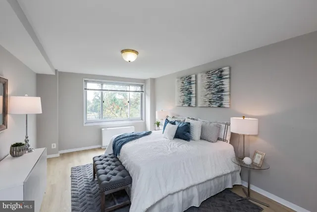 a bedroom with a bed and a large window