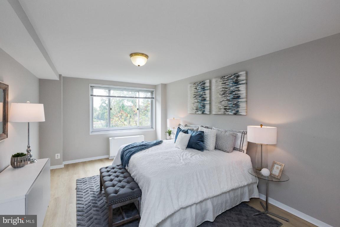 1900 Lyttonsville Road, Unit 714 Silver Spring, MD 20910 - Photo 11 of 22 a bedroom with a bed and a large window