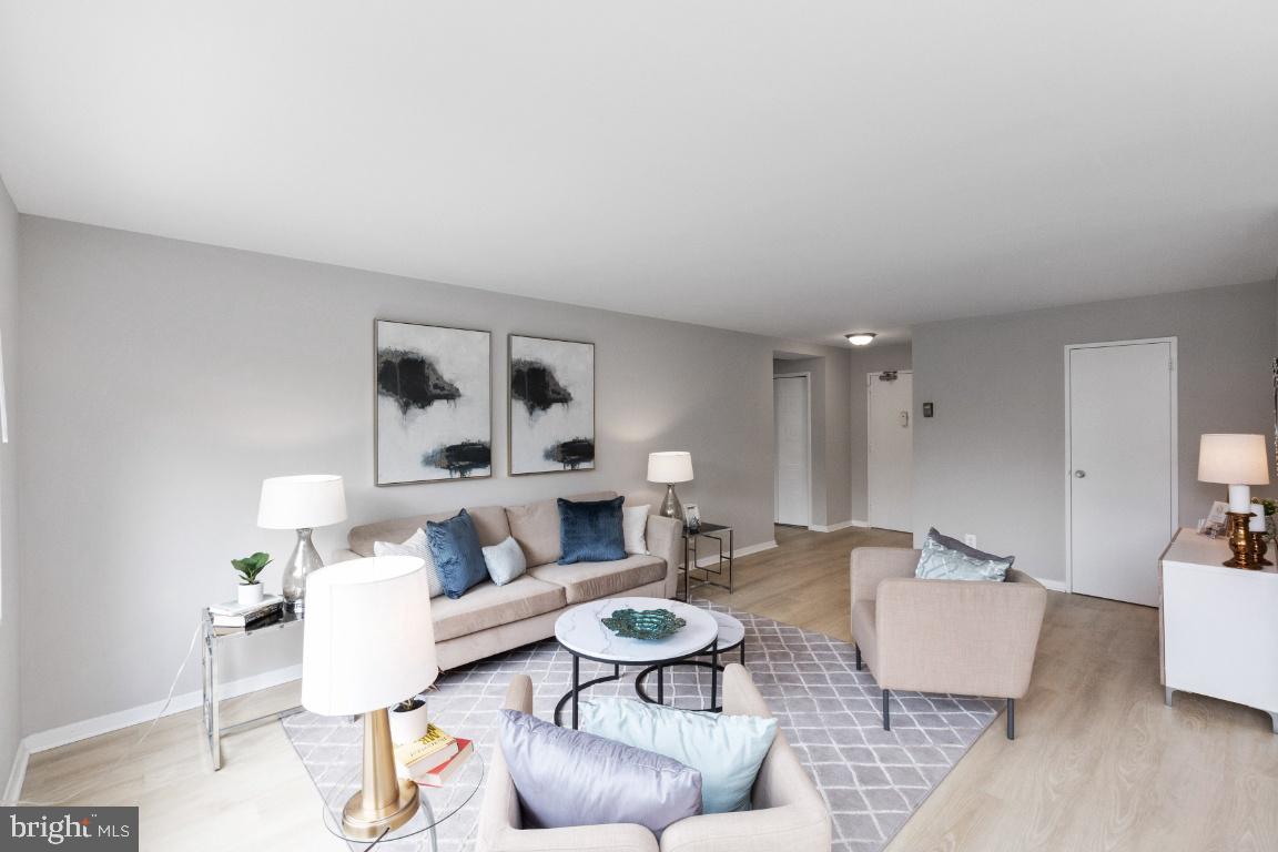 1900 Lyttonsville Road, Unit 714 Silver Spring, MD 20910 - Photo 2 of 22 a living room with furniture and a wooden floor