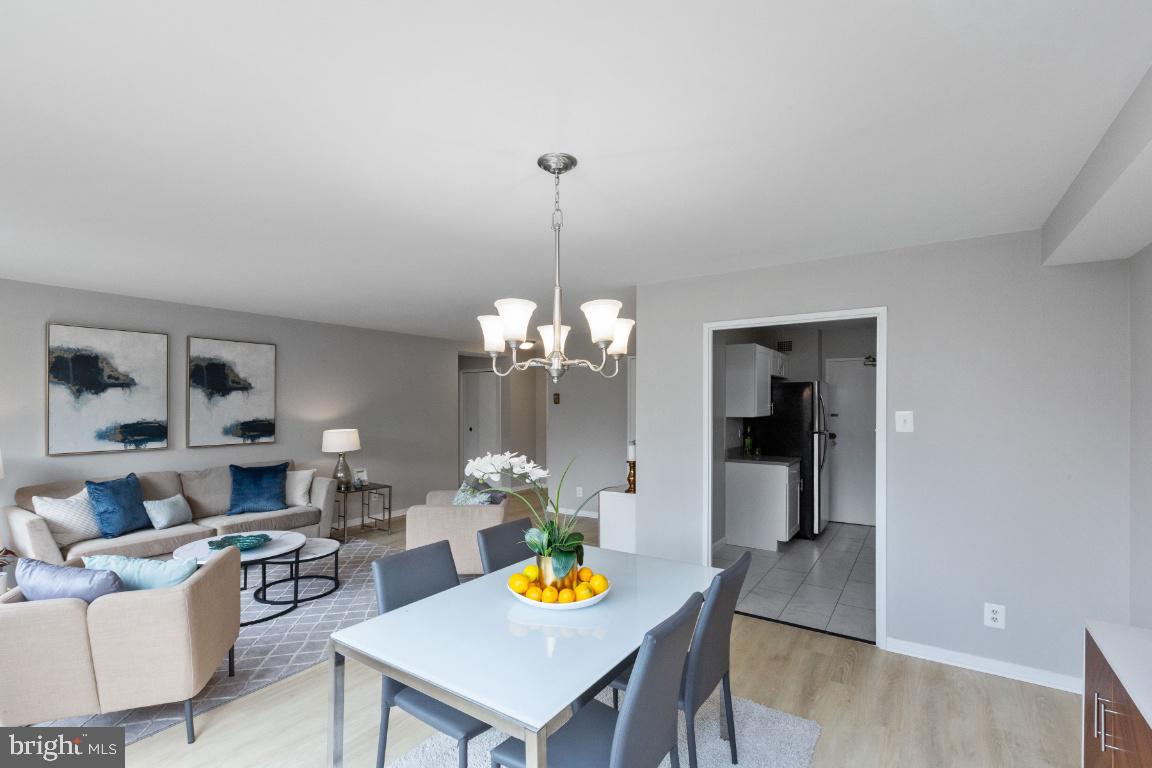 1900 Lyttonsville Road, Unit 714 Silver Spring, MD 20910 - Photo 4 of 22 a living room with furniture and a chandelier