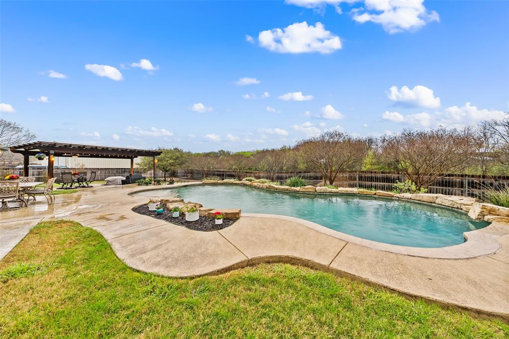 517 Chado Lane Robinson, TX 76706 - Photo 30 of 40 View of pool featuring patio surround, a fenced backyard, and a pergola