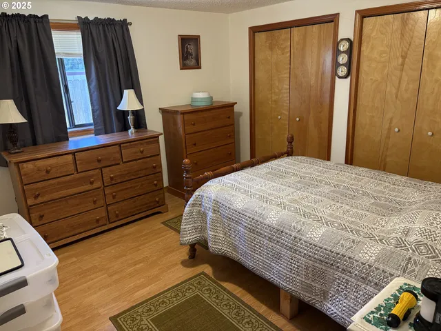 a bedroom with a bed and a dresser