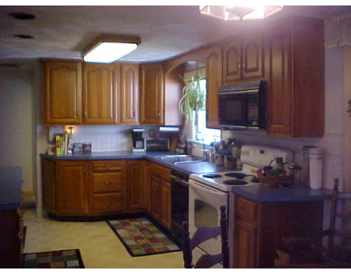 4 Westlake Road Natick, MA 01760 - Photo 3 of 3 a kitchen with stainless steel appliances a sink a stove a microwave a sink cabinets and a window