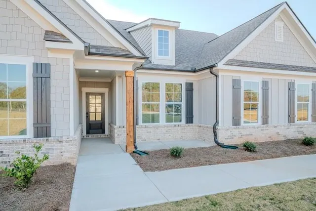 a front view of a house with a yard and glass windows