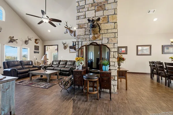 a living room with lots of furniture and wooden floor