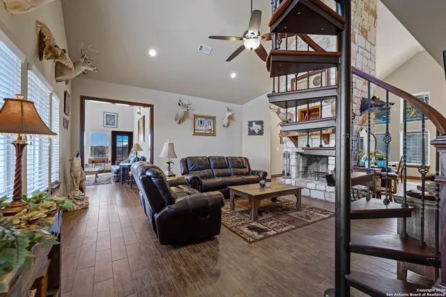 a living room with furniture a rug and a chandelier