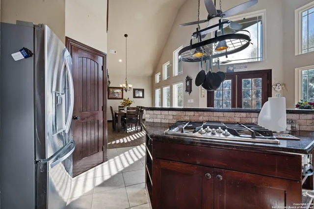 a kitchen with stainless steel appliances granite countertop a stove and a refrigerator