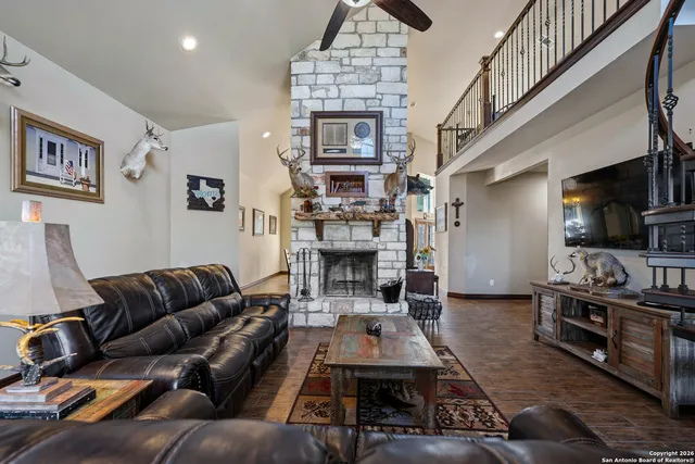 a living room with furniture fireplace and flat screen tv