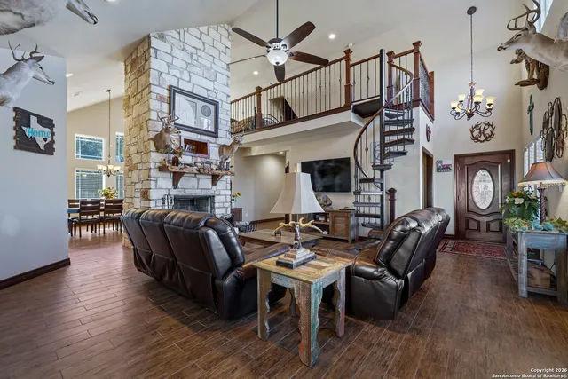 a living room with fireplace furniture and a wooden floor
