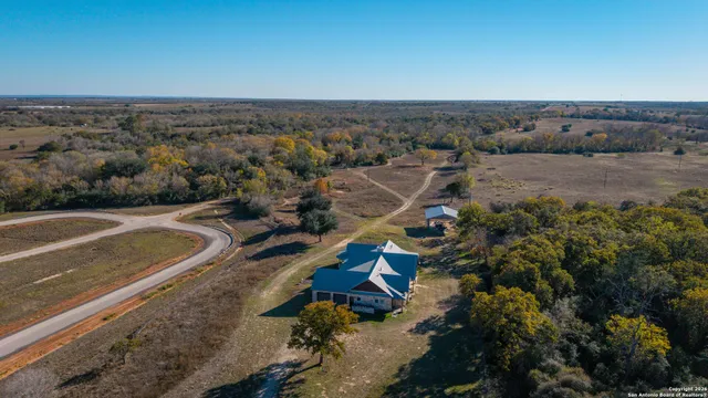 an aerial view of a house with a yard
