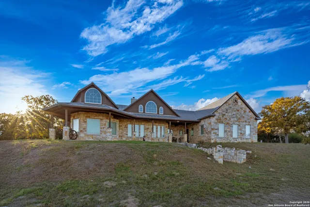 a front view of a house with a garden and yard