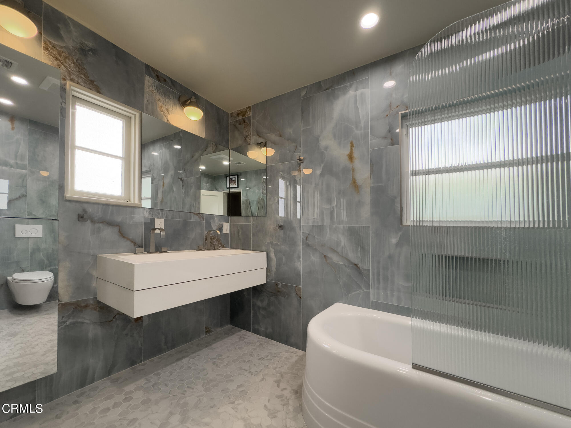 735 Prospect Drive Glendale, CA 91205 - Photo 33 of 49 a bathroom with a white bath tub a mirror and a shower