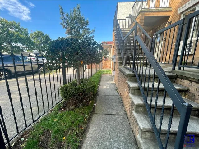a view of a patio with table and chairs with wooden fence and plants