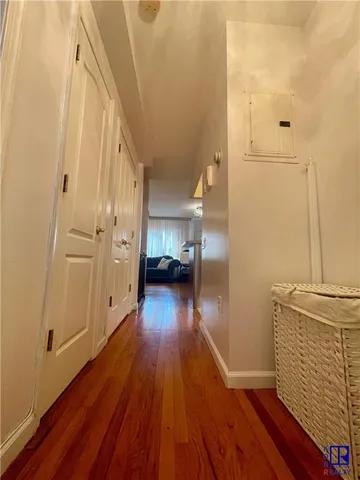 a spacious bedroom with a bed and a chandelier