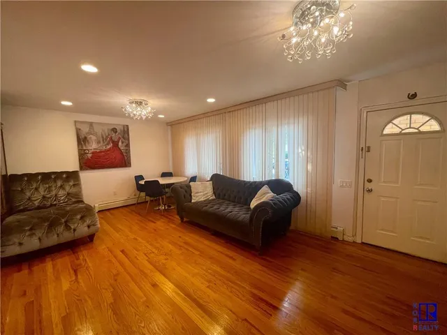 a room with a sink a refrigerator and cabinets