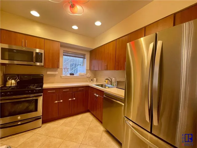 a bathroom with a granite countertop toilet sink and mirror