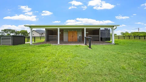 a view of a house with a yard and sitting area