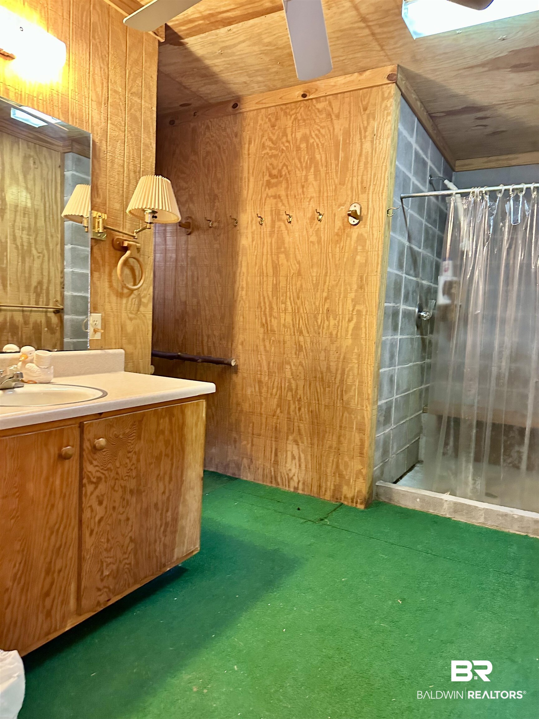 3881 Old Atmore Road Flomaton, AL 36441 - Photo 11 of 22 Bathroom with vanity, a shower with curtain, wood ceiling, and wooden walls