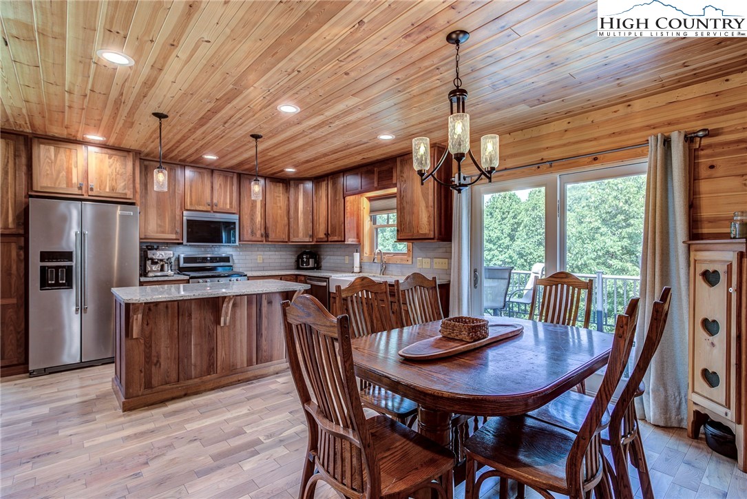 1210 Staghorn Road Purlear, NC 28665 - Photo 15 of 42 a view of a dining room with furniture window and outside view