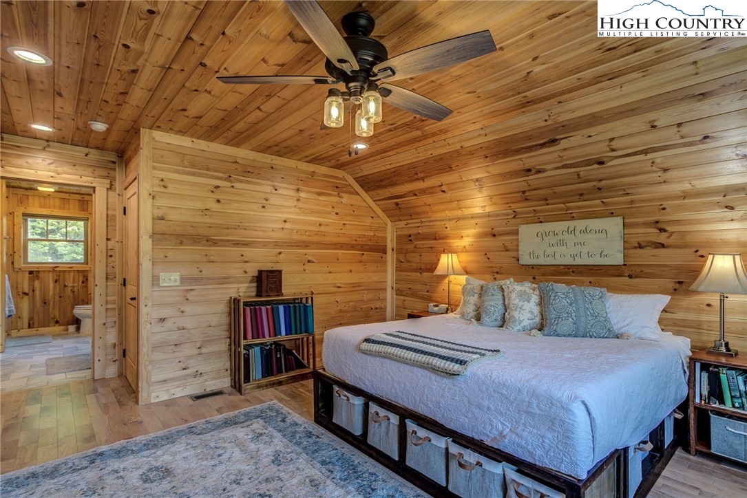 1210 Staghorn Road Purlear, NC 28665 - Photo 33 of 42 a bedroom with a bed and a bookshelf