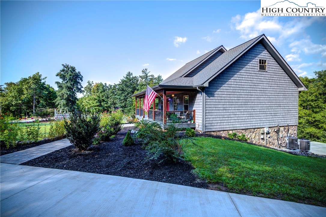 1210 Staghorn Road Purlear, NC 28665 - Photo 41 of 42 a front view of a house with garden