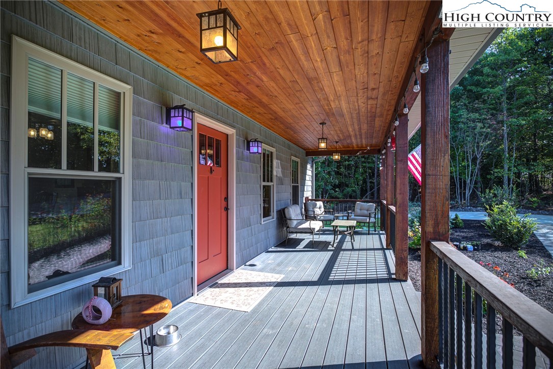 1210 Staghorn Road Purlear, NC 28665 - Photo 9 of 42 a patio with wooden floor and outdoor seating