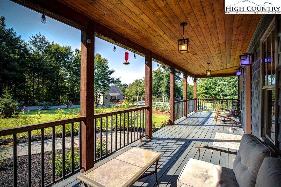 1210 Staghorn Road Purlear, NC 28665 - Photo 10 of 42 a view of balcony with wooden floor and outdoor seating