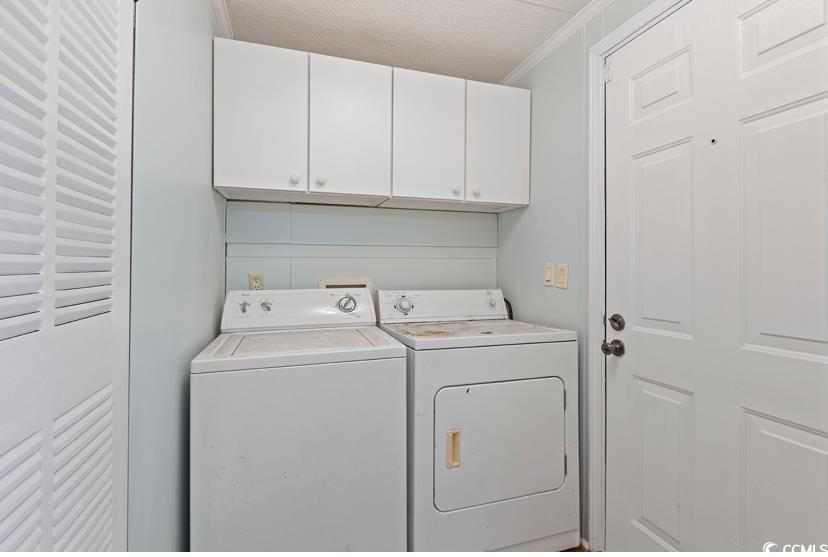 1030 Levi Street Manning, SC 29102 - Photo 18 of 31 Washroom with washer and dryer, cabinet space, and crown molding
