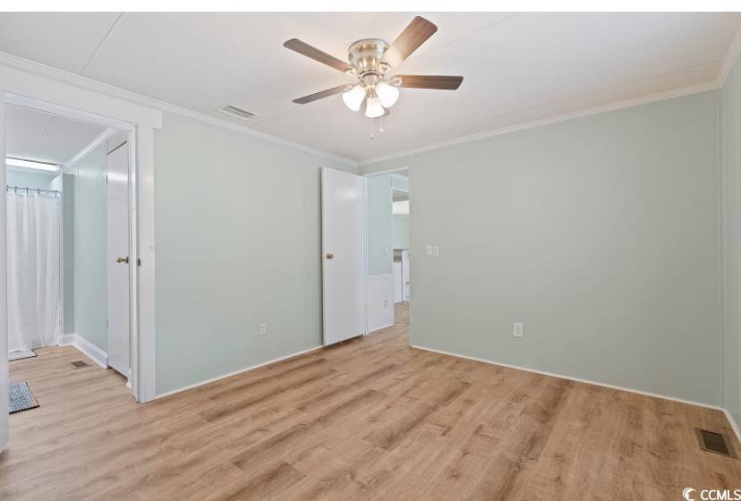 1030 Levi Street Manning, SC 29102 - Photo 19 of 31 Bedroom with light wood-type flooring, ornamental molding, baseboards, and ceiling fan