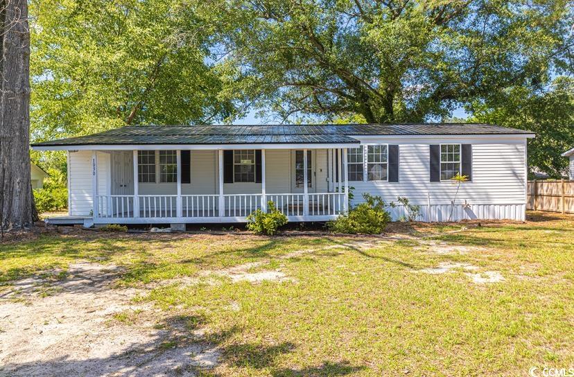 1030 Levi Street Manning, SC 29102 - Photo 2 of 31 View of front facade featuring covered porch and metal roof