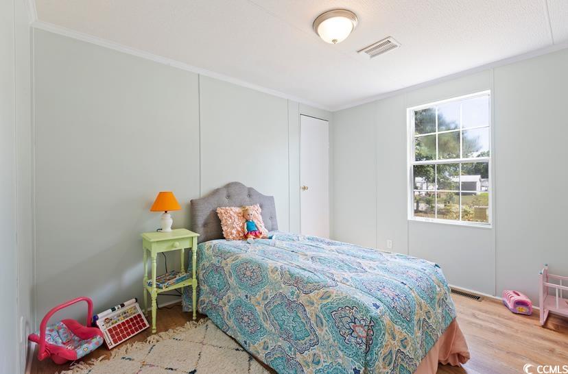 1030 Levi Street Manning, SC 29102 - Photo 25 of 31 Bedroom featuring crown molding and wood finished floors