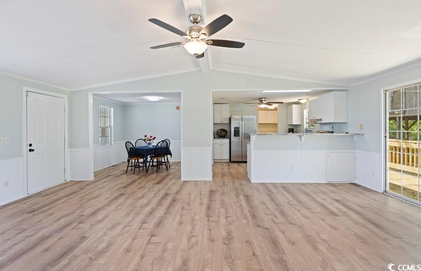 1030 Levi Street Manning, SC 29102 - Photo 9 of 31 Living area featuring a ceiling fan, light wood-style floors, wainscoting, and ornamental molding