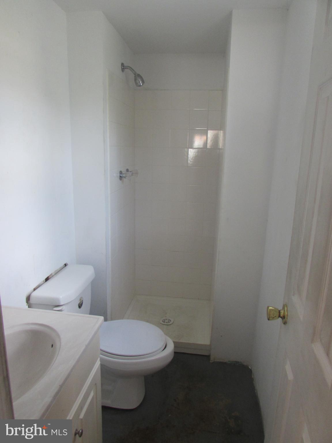 3507 Oaklawn Road Fort Washington, MD 20744 - Photo 14 of 16 a white toilet sitting next to a bathroom sink and vanity