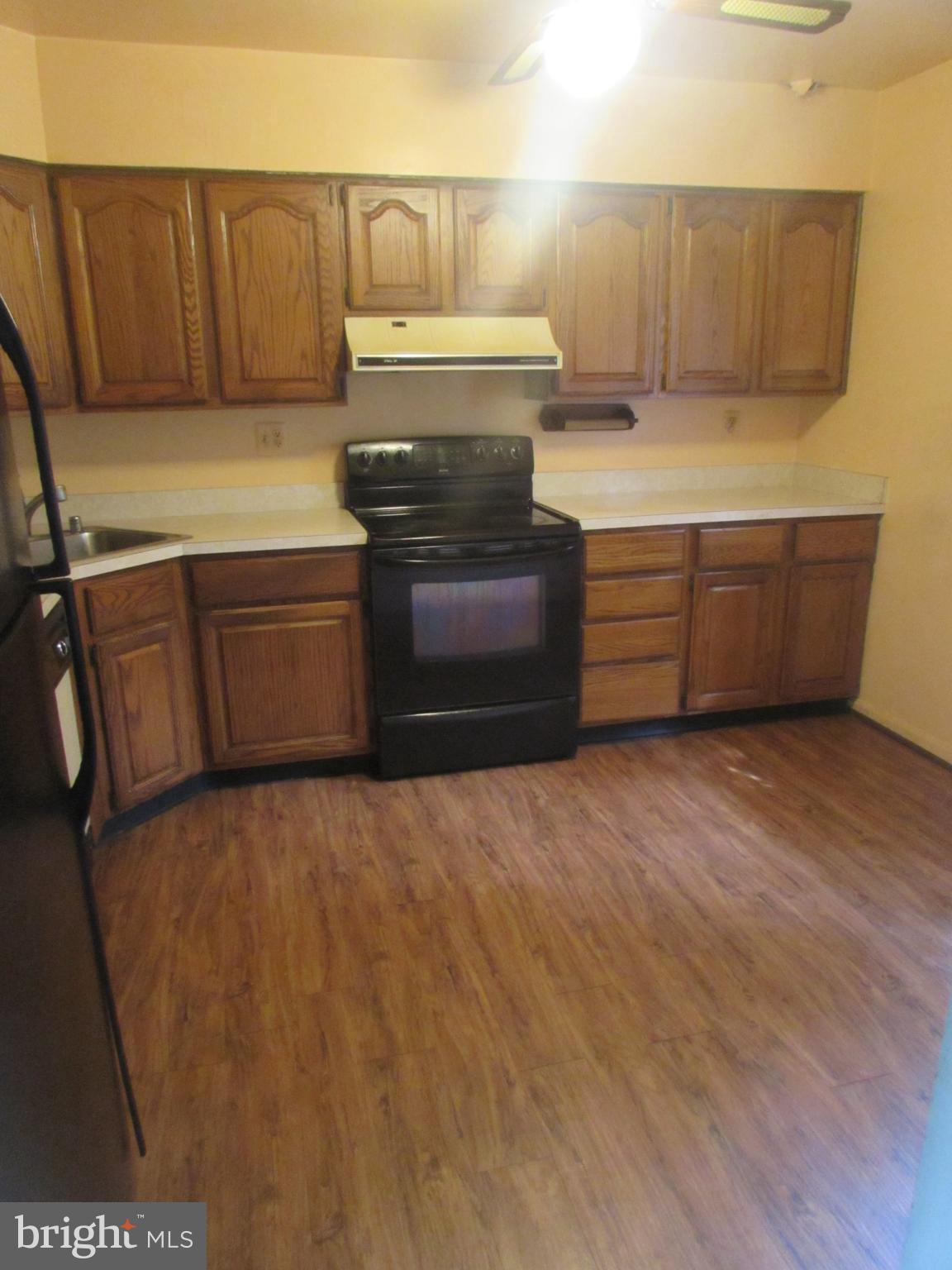 3507 Oaklawn Road Fort Washington, MD 20744 - Photo 5 of 16 a kitchen with stainless steel appliances wooden cabinets and a sink