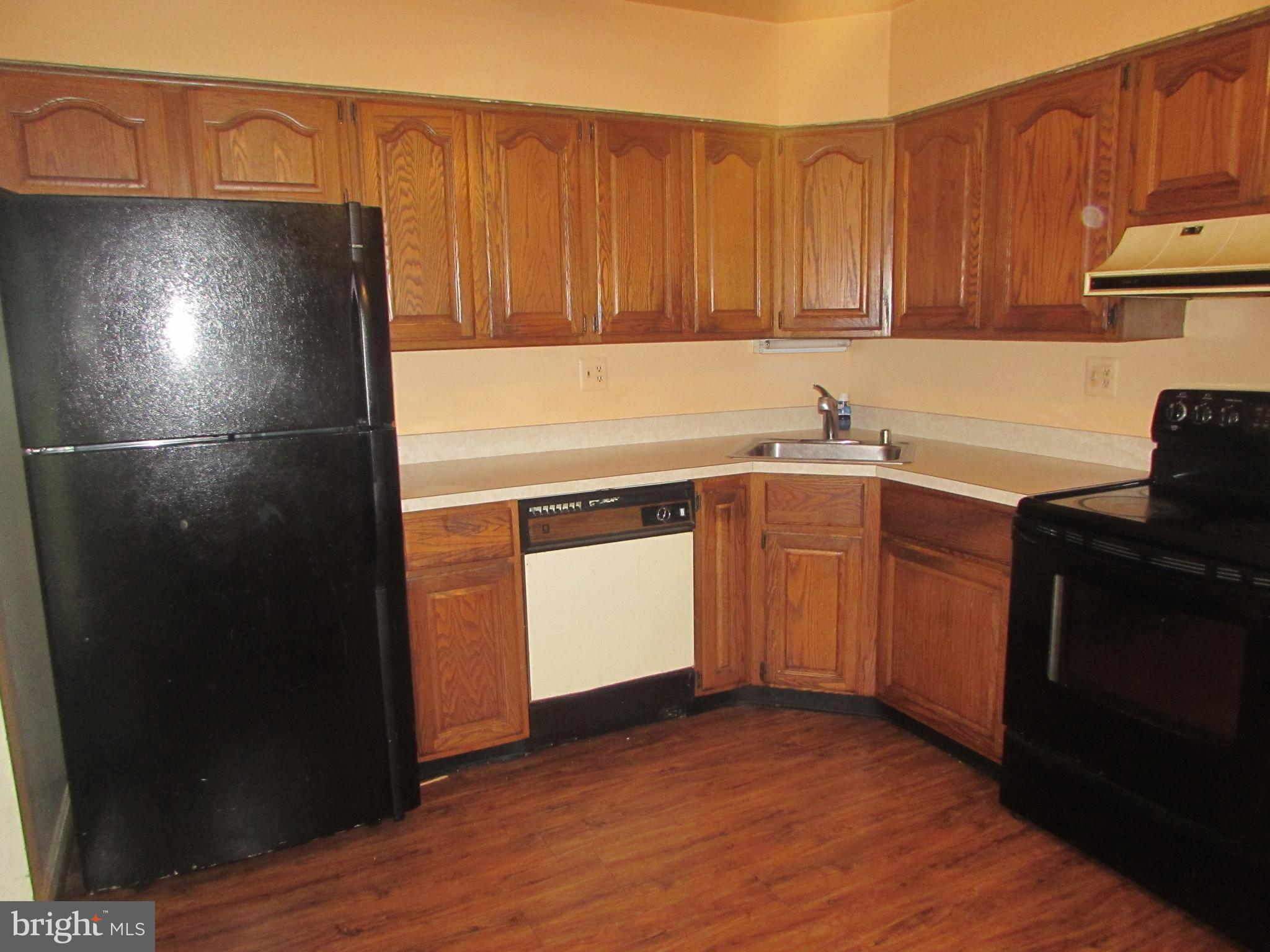 3507 Oaklawn Road Fort Washington, MD 20744 - Photo 6 of 16 a kitchen with a sink and a refrigerator