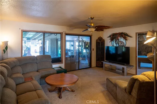 a room with pool table and windows