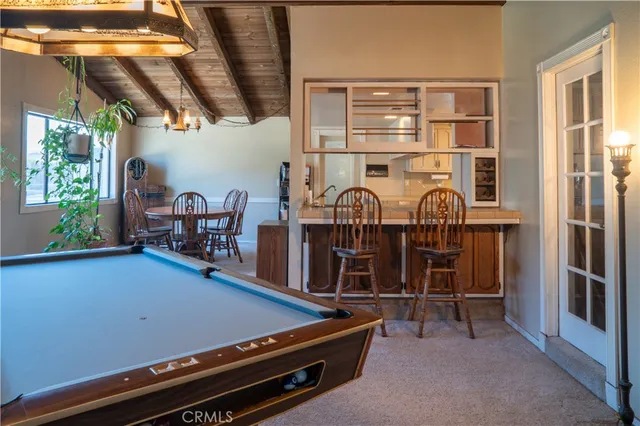 a large kitchen with stainless steel appliances granite countertop a refrigerator and a stove