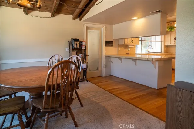 a kitchen with white cabinets and refrigerator
