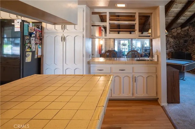 a kitchen with a stove a sink and a refrigerator