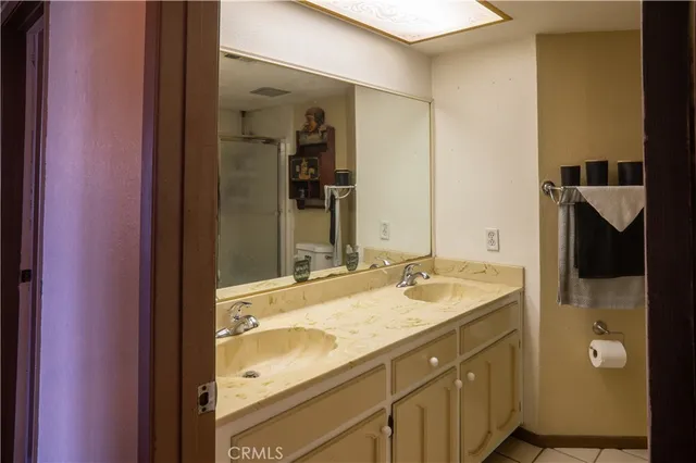 a living room with furniture a chandelier and a flat screen tv